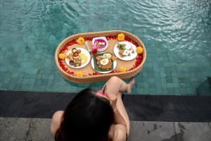 an overhead view of a table of food in a pool at Padi Bali Villa With Private Jacuzzi in Payangan