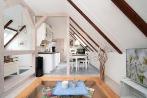 a kitchen and dining room in a tiny house at Landstuuv in Neustadt in Holstein +22 photos