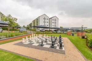 a chess board on a lawn in front of a building at EdenNest in Boksburg