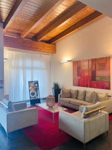 a living room with two couches and a red rug at Hotel Gallia in Pianezza