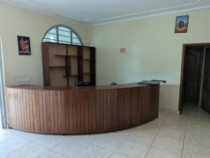 a large wooden reception desk in a room at Gorilla Trekking Guest House in Ruhengeri