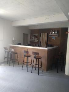 a bar with stools around a counter in a room at C'VAR Residential Vacation Apartment Rentals in Saint Michael