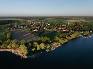 an aerial view of a village on the shore of a lake at Naturhaus Havelland in Rathenow