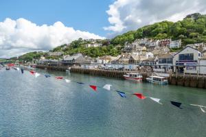 a row of flags in the water near a town at 1 Bed in West Looe oc-1west in Looe +1 photo