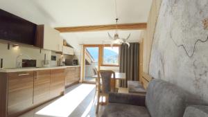 a kitchen with a couch and a dining room at Ferienwohnungen Braiter in Rifiano