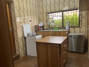 a small kitchen with a stove and a refrigerator at Ined Apartment Services in Ibadan