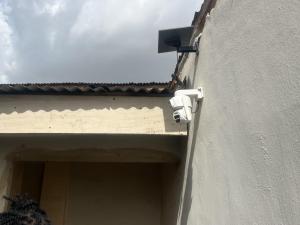 a security camera on the side of a building at Ined Apartment Services in Ibadan