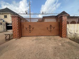 a garage door with a gate with a fence at Ined Apartment Services in Ibadan