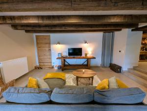 a living room with a couch and a table at Gite L étable du Bien Etre in Ray-sur-Saône