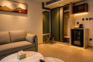 a living room with a couch and a fireplace at Coral Beach Hotel & Spa in Aqaba