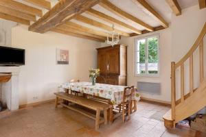 a dining room with a table and a window at Le Bourg Joly in Rigny-Ussé