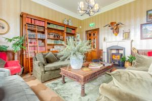 a living room with a coffee table and a fireplace at Muckrach Country House in Skye of Curr