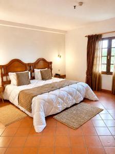 a bedroom with a large bed in a room at Hotel Quinta Da Lagoa in Praia de Mira +29 photos
