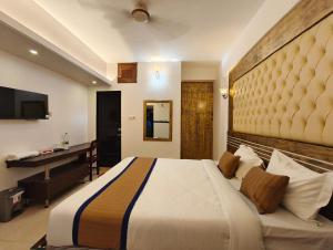 a hotel room with a large bed and a desk at The White Beach Resort in Cox's Bazar