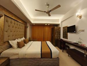 a bedroom with a large bed and a desk at The White Beach Resort in Cox's Bazar