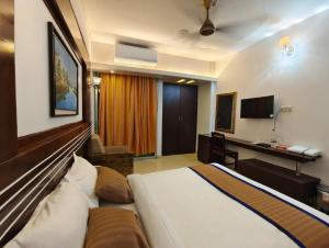 a hotel room with a bed and a desk at The White Beach Resort in Cox's Bazar +33 photos