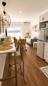 a kitchen and living room with a table and chairs at Modern Unit Near CBD & Beach, Free Parking in Perth