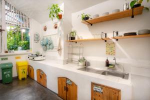 a kitchen with a sink and wooden cabinets at Snooze Yogyakarta in Yogyakarta