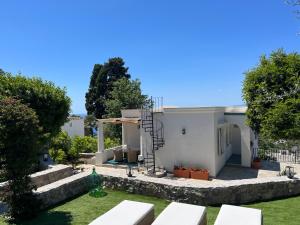 a white house with a garden and stairs at Villa Claudia in Anacapri