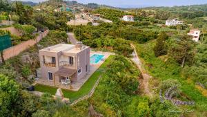 an aerial view of a house with a swimming pool at Villa Rubin in Almyrida +32 photos