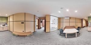 a room with a couch and a table in a building at Set Sail Hotel in Oral
