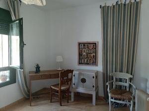 a room with a desk and a chair and a window at Beautiful Duplex with a Patio in Alcalá de los Gazules