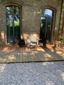 a patio with chairs and tables on a brick building at Loft19 in Euskirchen
