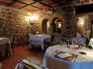 a restaurant with two tables with white table cloth at castello di sovicille in Sovicille