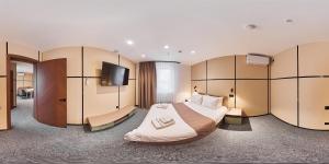 a hotel room with a large bed and a flat screen tv at Set Sail Hotel in Oral +35 photos
