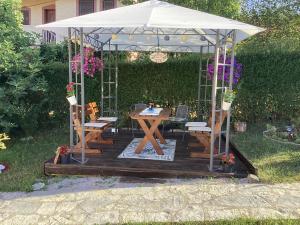 a gazebo with a table and chairs under it at Vila Siki in Rakari