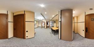 a row of doors in a room with a table at Set Sail Hotel in Oral