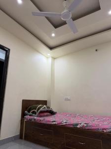 a bed in a room with a ceiling fan at Abc HOTEL & LODGE in Biratnagar