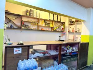 a room with a counter and shelves with water bottles at Abc HOTEL & LODGE in Biratnagar +1 photo