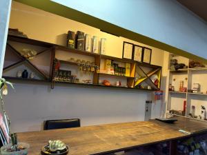 a room with a table and shelves on the wall at Abc HOTEL & LODGE in Biratnagar