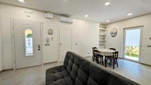 a living room with a couch and a table at Alloggio Turistico Francy House in Lido dei Pini