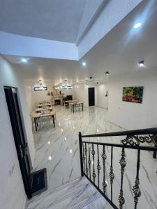 a living room with a staircase and a dining room at Likani Stay in Borjomi