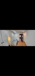 a living room with a bed and a hallway at Torrent in Torrent