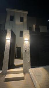 a building with two stone pillars with lights on it at the garden in Hail