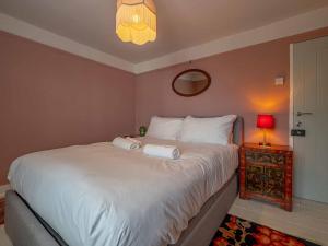 a bedroom with a bed with two towels on it at Seagrass Cottage - 3bed, Private Parking, Secluded Garden, Minutes from Whitstable town in Whitstable