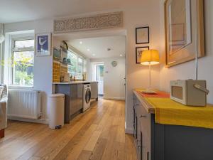 a kitchen with a sink and a counter with a microwave at Seagrass Cottage - 3bed, Private Parking, Secluded Garden, Minutes from Whitstable town in Whitstable