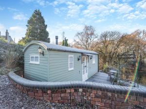 a small shed with a brick retaining wall at The Shepherds Rest - Uk45532 in Buildwas