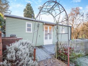 a small green house with a gate in front of it at The Shepherds Rest - Uk45532 in Buildwas