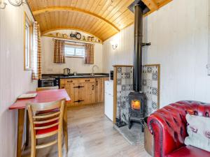 a kitchen and living room with a wood stove at The Shepherds Rest - Uk45532 in Buildwas