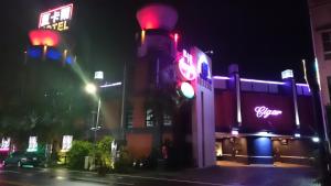 a traffic light in front of a building at night at Cigar Motel in Tainan