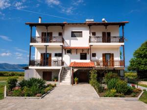 a large white building with balconies on it at Pilgrimos Apartments in Ierissos
