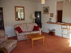 a living room with a couch and a coffee table at The Pottery Annexe in Baslow