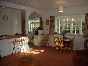 a kitchen and living room with a table and chairs at The Pottery Annexe in Baslow