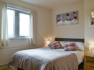 a bedroom with a bed and a window at Ribblestones in Austwick +10 photos