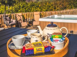a tray with a tea pot and cups on a table at Ash Lodge At Lon Lodges in Nantmel