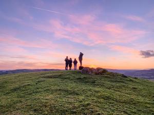 a group of people standing on top of a hill at Ash Lodge At Lon Lodges in Nantmel +20 photos